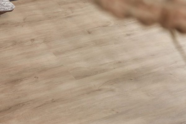 Extra brede landhuis‑PVC plank in zachte eikenlook met subtiele grijze ondertoon, voelbare houtstructuur en mat MEGAMAT‑afwerking.